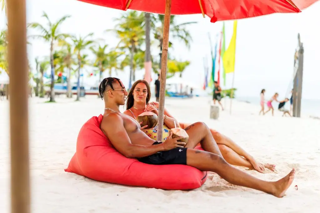 Couple relaxing on Jungutbatu Beach in Nusa Lembongan.